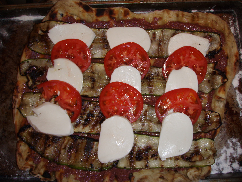 With toppings, before being returned to the grill 